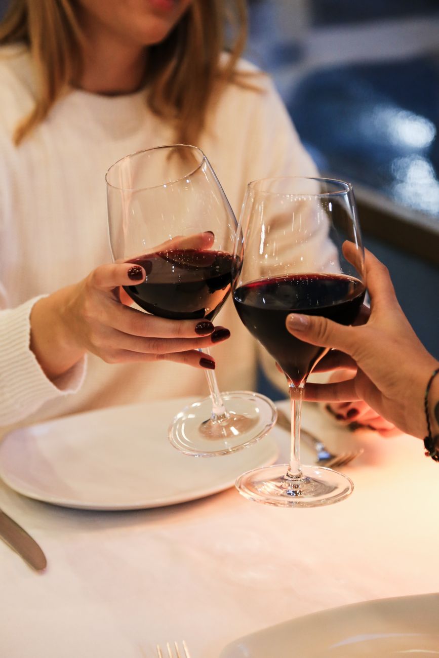 friends toasting with red wine at dinner