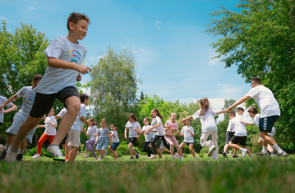 A group of children happily playing in a sunny park, enjoying outdoor activities and fun.