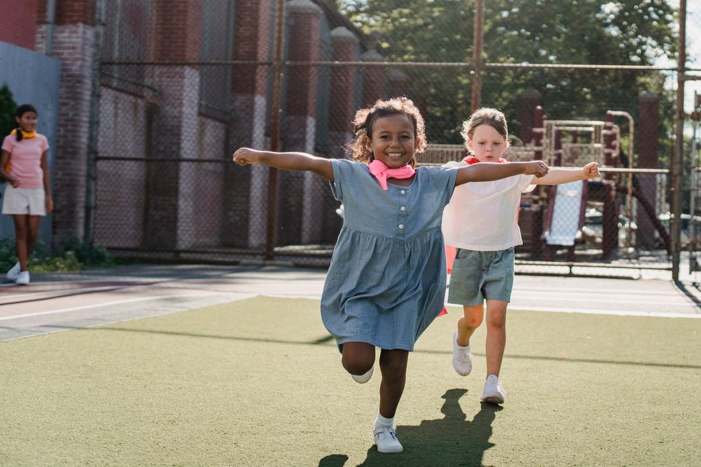 Happy children enjoying outdoor playtime at a local playground, running and exploring.